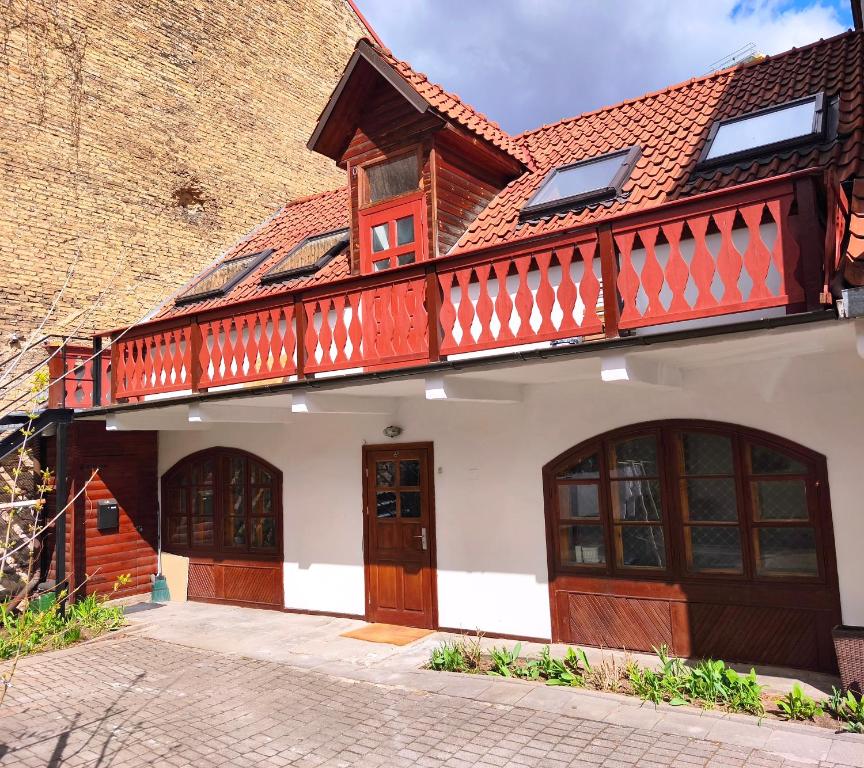 a house with a balcony on top of it at Prime Location Apartment Vilnius in Vilnius