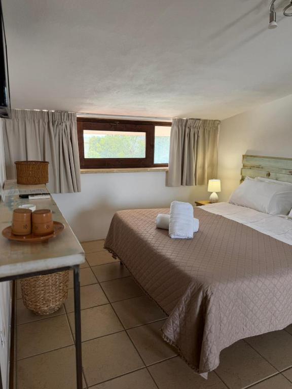 a bedroom with a bed with two towels on it at Agriturismo Pietragrande in Otranto