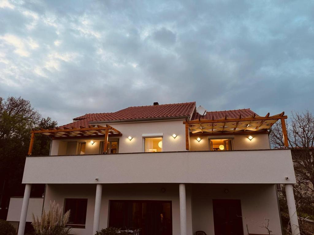a house with a balcony on top of it at Marija in Pakoštane