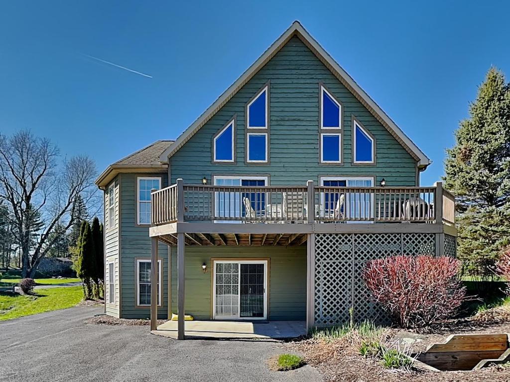 a house with a deck and a balcony at Ski Boots N Bathing Suits in McHenry