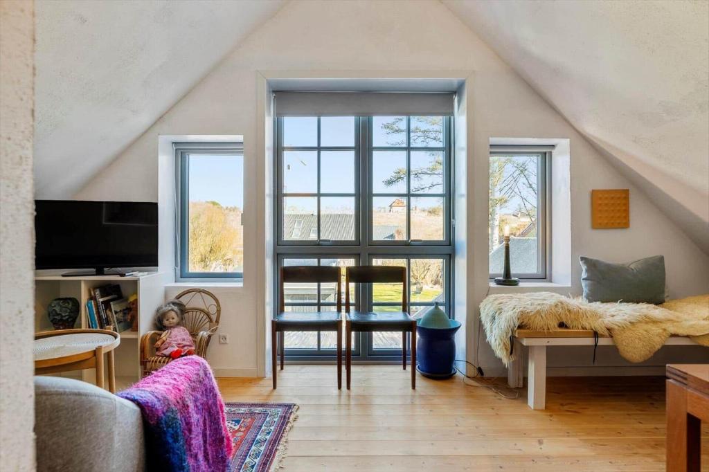 a living room with a large window and a couch at LN2056-Hjorring-Strandvejen-56 in Lønstrup