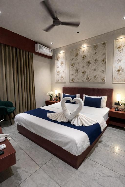 a bedroom with a large bed with two swans on it at Hotel Maharaja 2 in Udaipur