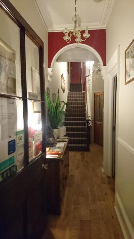 a hallway with a staircase in a building at Lawnswood Guest House in Torquay