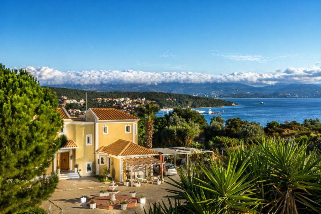 a house with a view of the water at Acqui Apartments in Argostoli