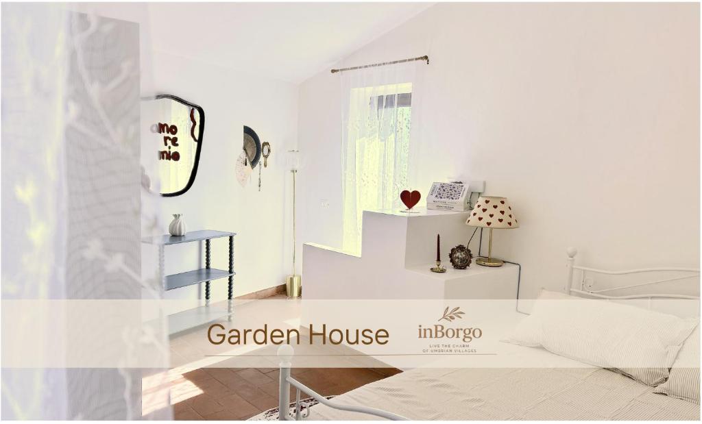 a white room with a white couch and a table at Garden House - InBorgo in Acquasparta
