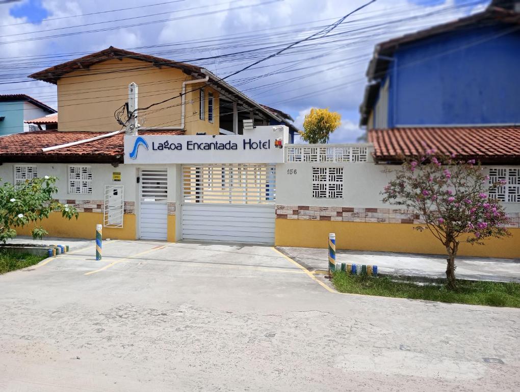 a house with a garage door in front of it at Lagoa Encantada I in Ilhéus