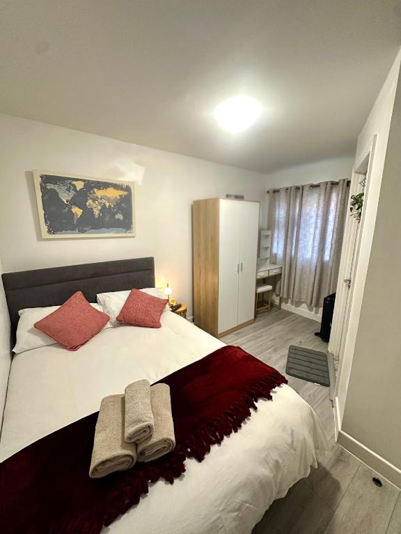 a bedroom with a large bed with two towels on it at Little Gem in Dublin