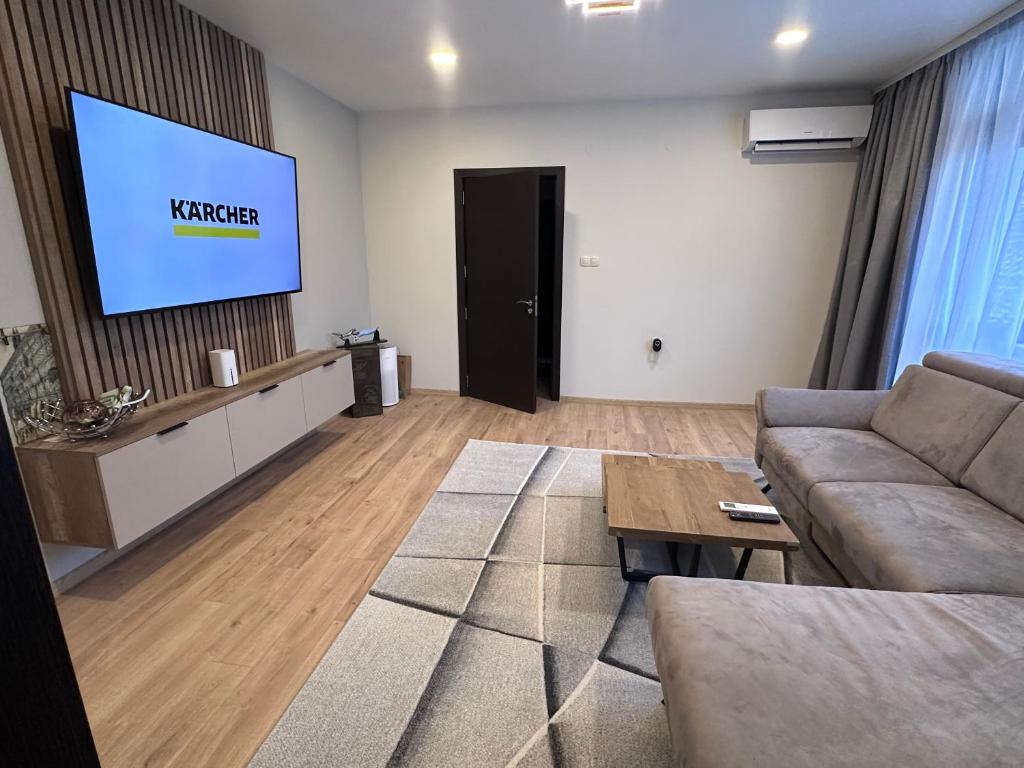 a living room with a couch and a tv at Central Stara Zagora Apartment in Stara Zagora