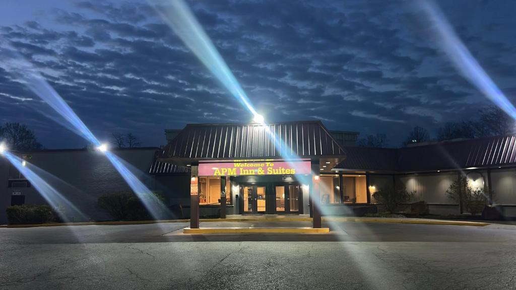 a building with lights in front of it at night at APM Inn & Suites in Martinsburg