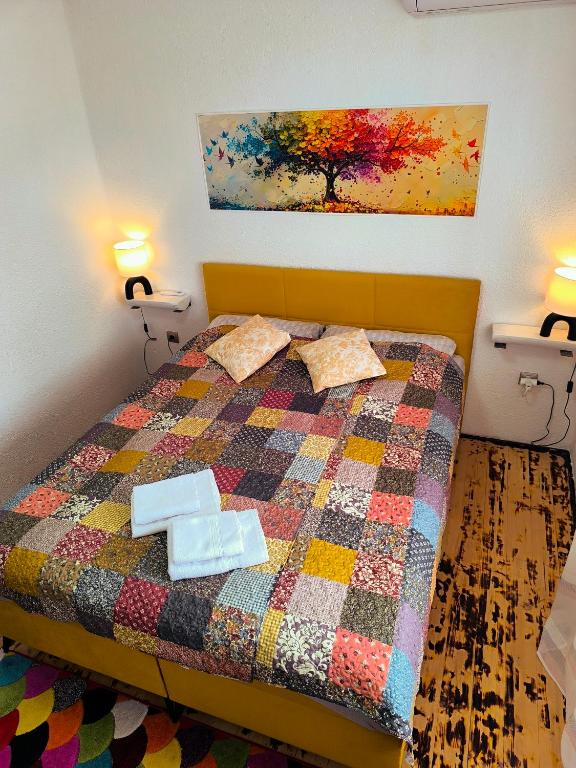 a bedroom with a bed with two towels on it at Sárkányszikla Apartman in Nemti