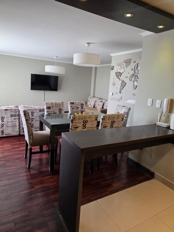 a dining room with a black table and chairs at Caseros Desings Salta in Salta