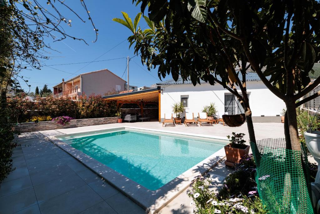 a swimming pool in the backyard of a house at HoUsE MILETIC in Solin