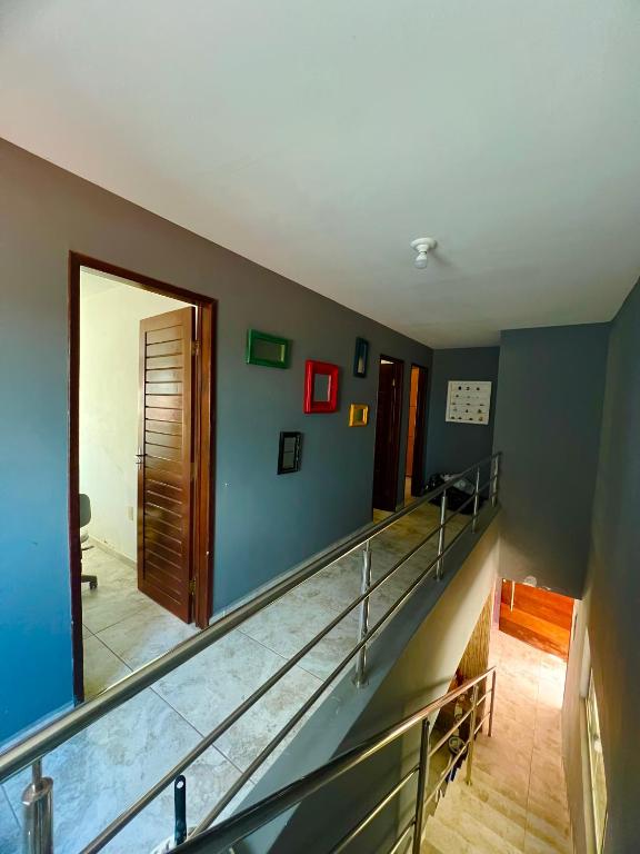 a view of a staircase in a room with blue walls at Casa Brisa do Mar in Cabedelo