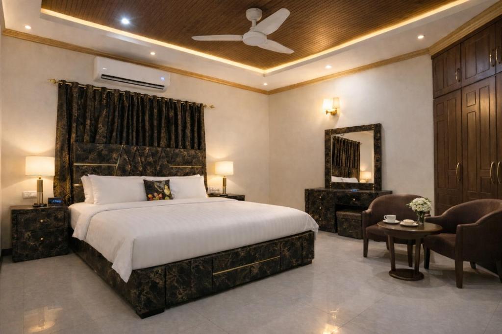 a bedroom with a bed and a table and chairs at Morbex Inn Hotel Islamabad in Islamabad