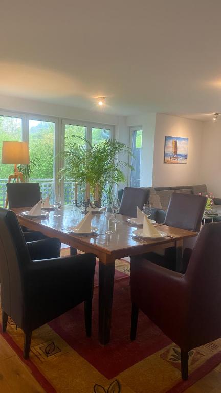 a table in a room with chairs and a table with at Bright Rooms with WiFi , Terrace between Freiburg and France , private Zimmer in Freiburg im Breisgau