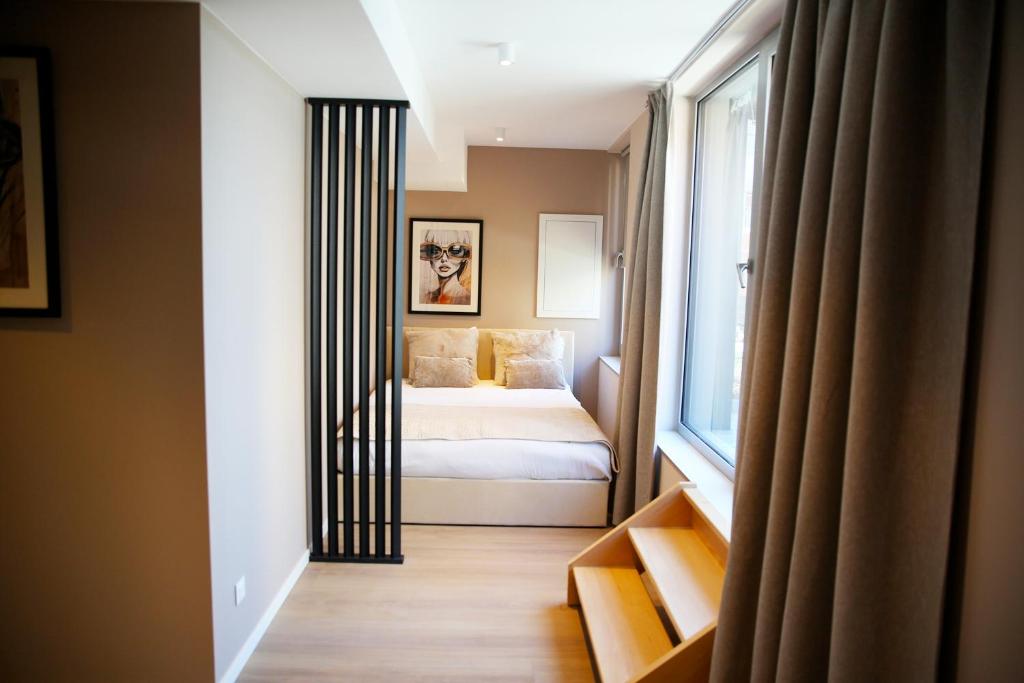 a bedroom with a bed and a window at Prime apartment in Liège