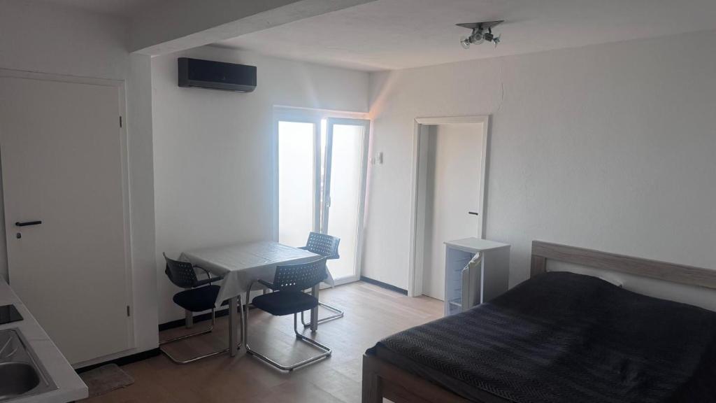 a bedroom with a desk and a bed and a table at Barth Apartments in Donji Štoj
