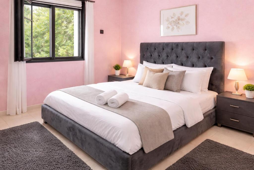 a bedroom with a large bed with two towels on it at Residence Mly youssef appart in Safi