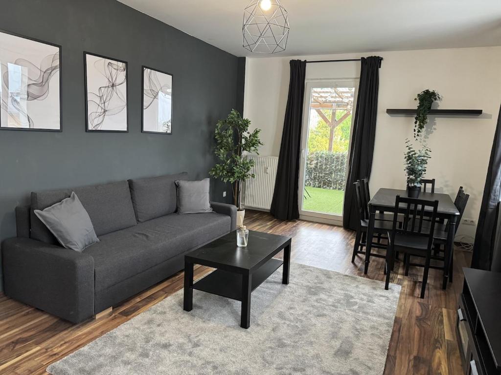 a living room with a couch and a table at 2BR, terrace, free parking in Leverkusen