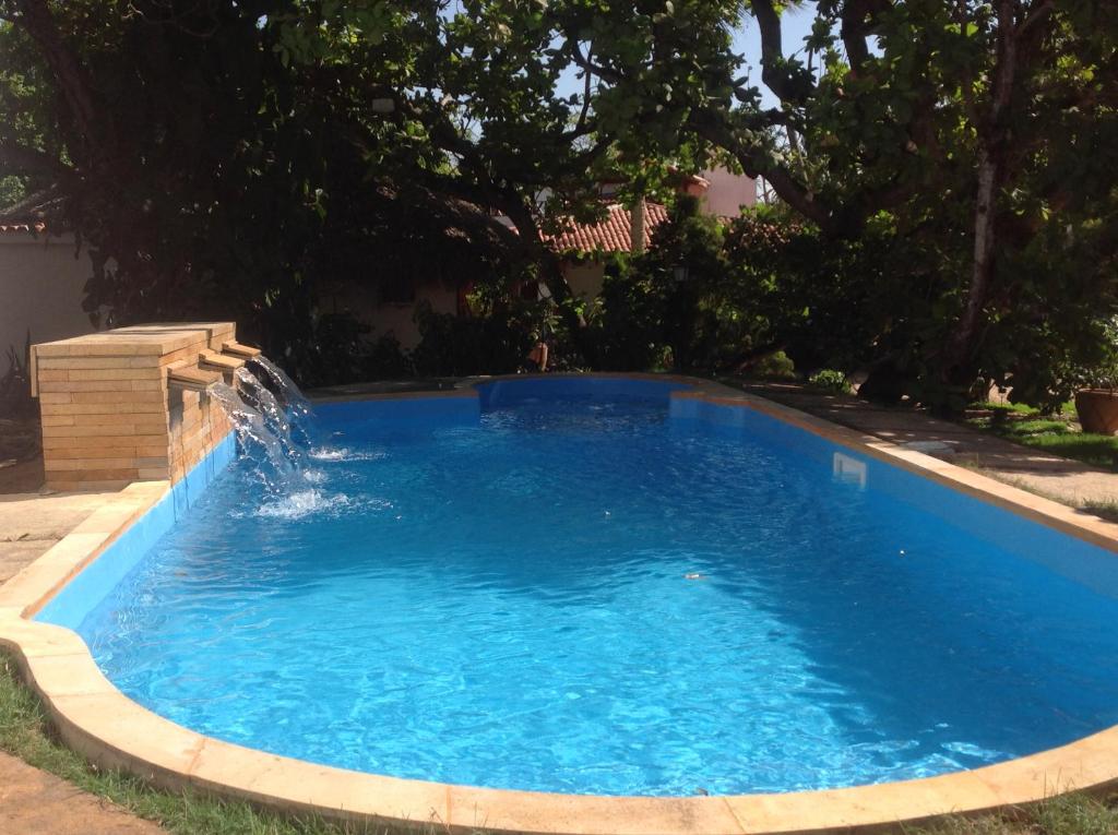 uma piscina com uma fonte de água num quintal em Pousada Villa Caju em Jericoacoara