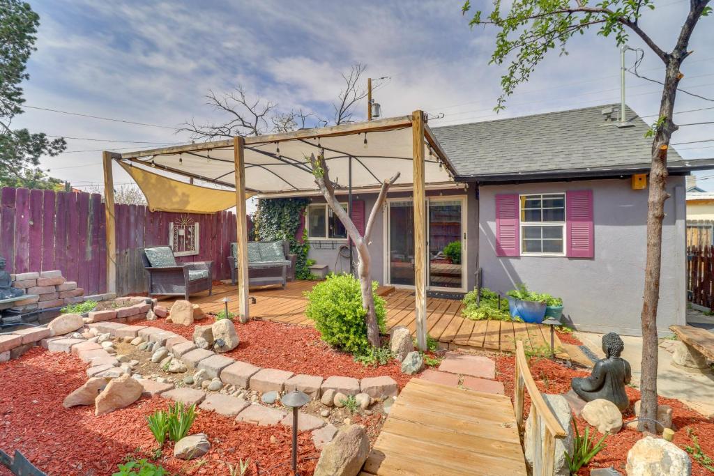 a backyard with a wooden deck with a pergola at Walk to Downtown! ABQ Couple's Studio w/ Deck in Albuquerque