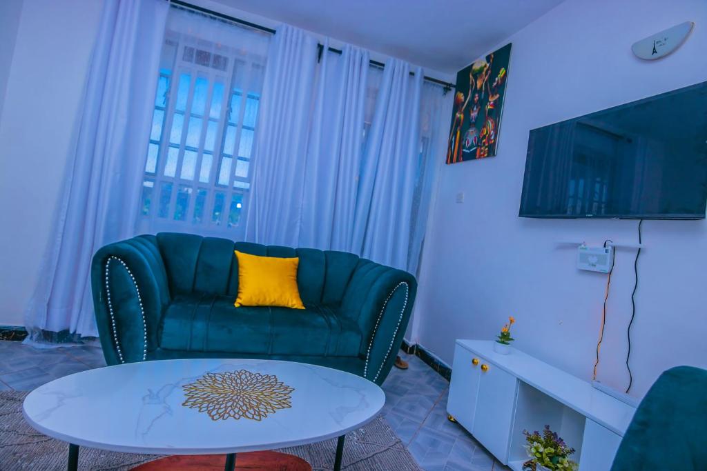 a living room with a couch and a table at Zariah Homes 1BR Ksm in Kisumu
