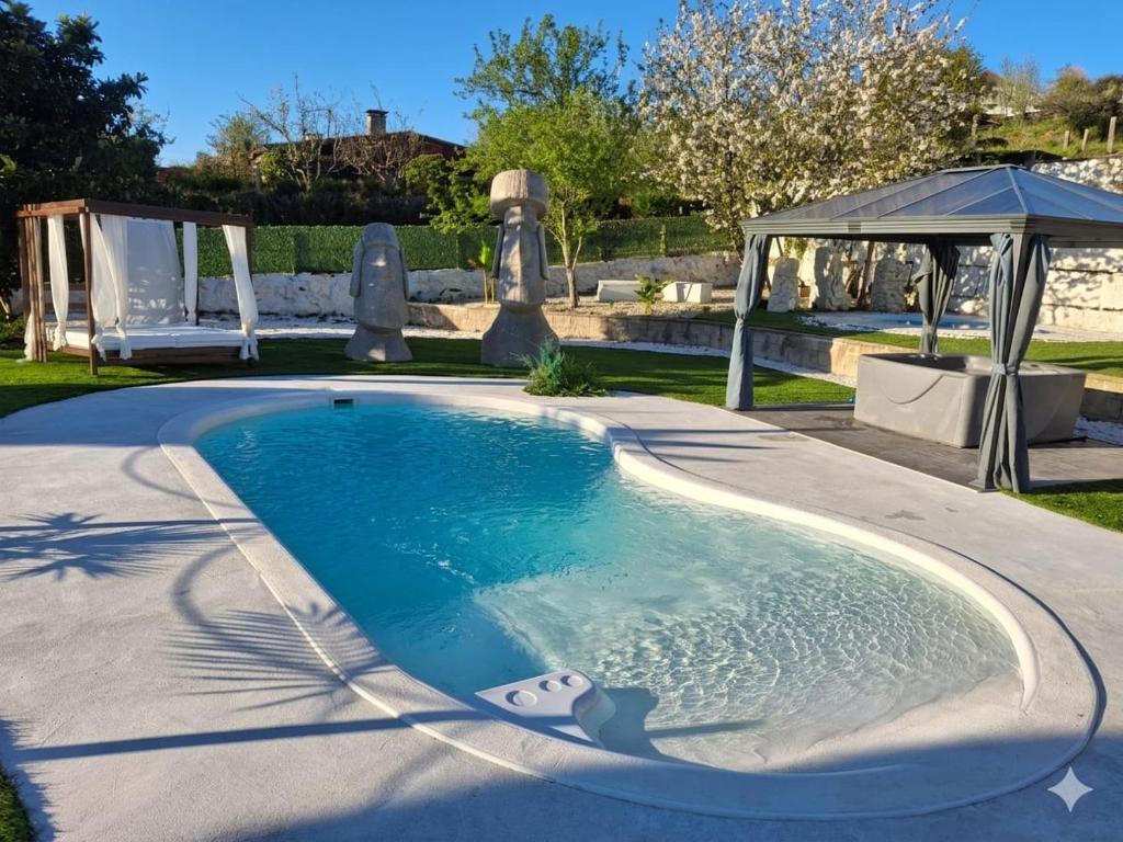 a swimming pool in a yard with a gazebo at Marcemar in Borbén