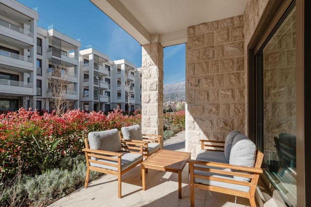 a patio with chairs and a table and a building at River side apartment B3 in Herceg-Novi