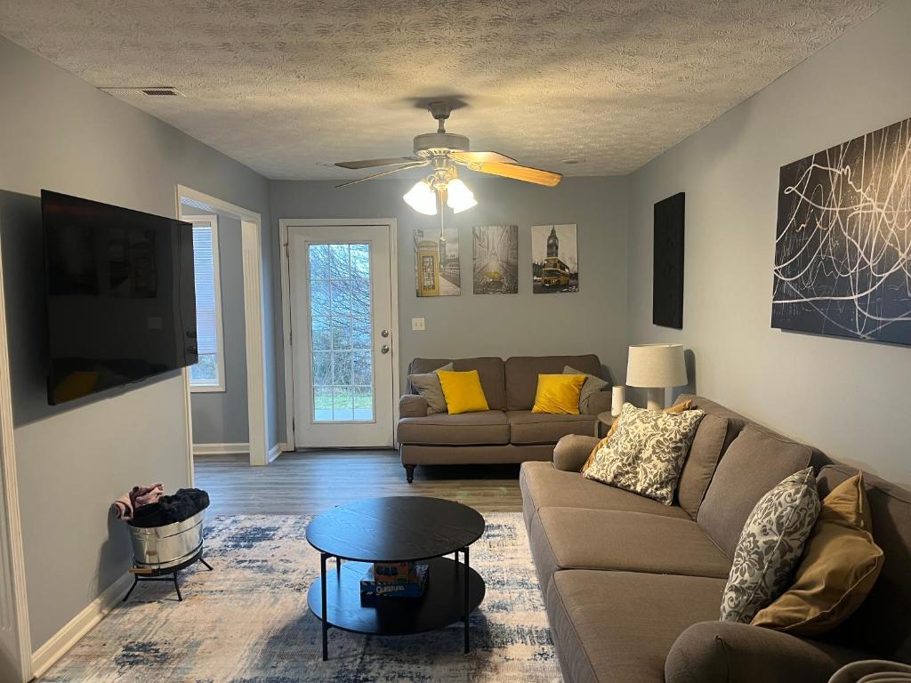 a living room with a couch and a table at Stylish 3BR Townhouse in Radcliff