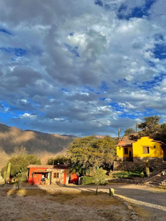 a yellow house on the side of a road at Casas de Juella -Juella-Tilcara in Tilcara