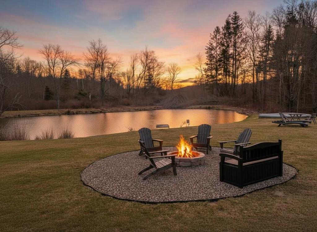 a fire pit in a yard with chairs and a pond at Chic Renovated Chalet with Private Pond in Roscoe