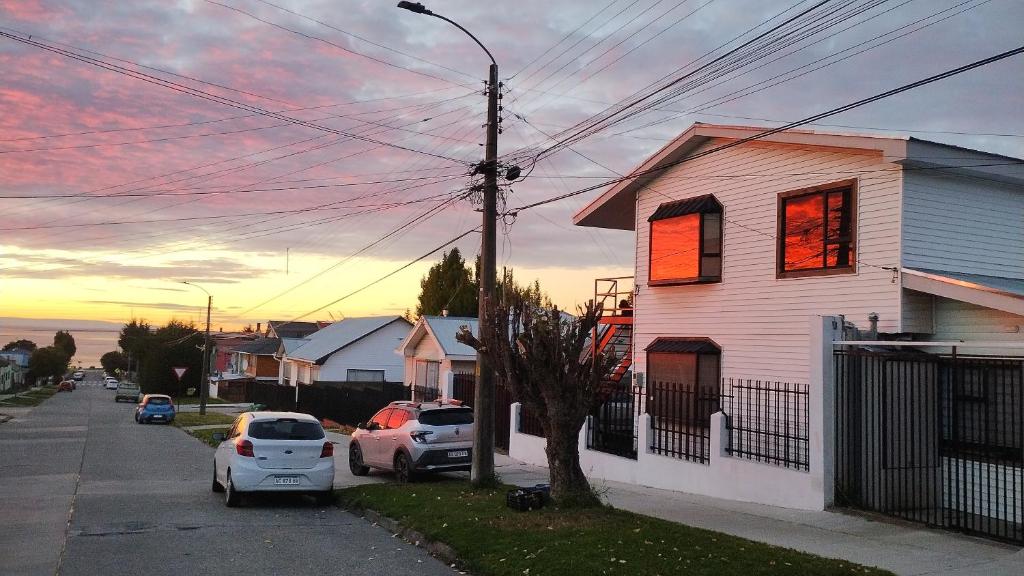 a house on a street with cars parked in front of it at Departamento Independiente a 2 cuadras de Costanera in Punta Arenas