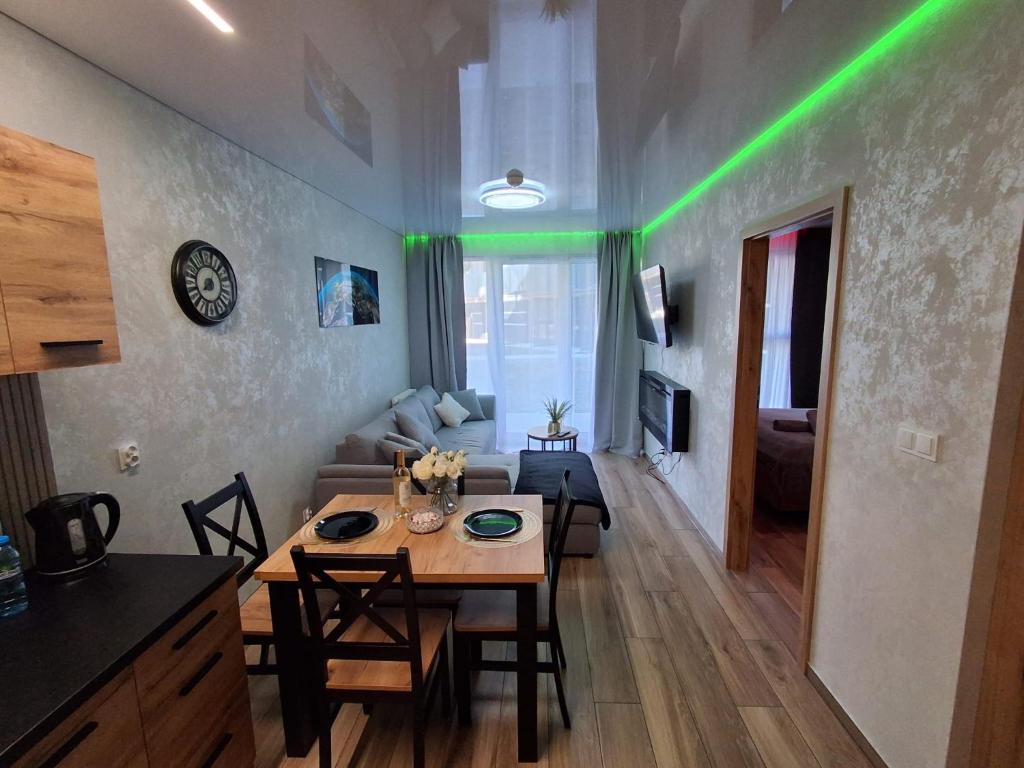 a living room with a table and a couch at Mostique Spa Apartment with Jacuzzi in Gdańsk