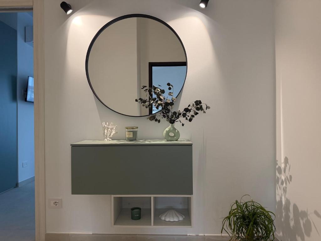 a bathroom with a sink and a mirror at Ferraro Apartments in Campora San Giovanni