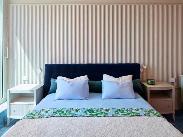 a bedroom with a bed with two pillows on it at כוכב קיסר in Caesarea