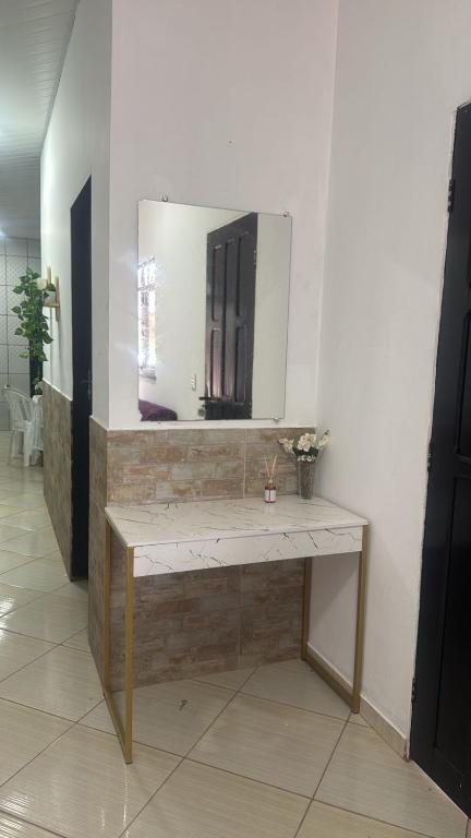 a bathroom with a sink and a mirror on a wall at Casa Borges leal in Santarém