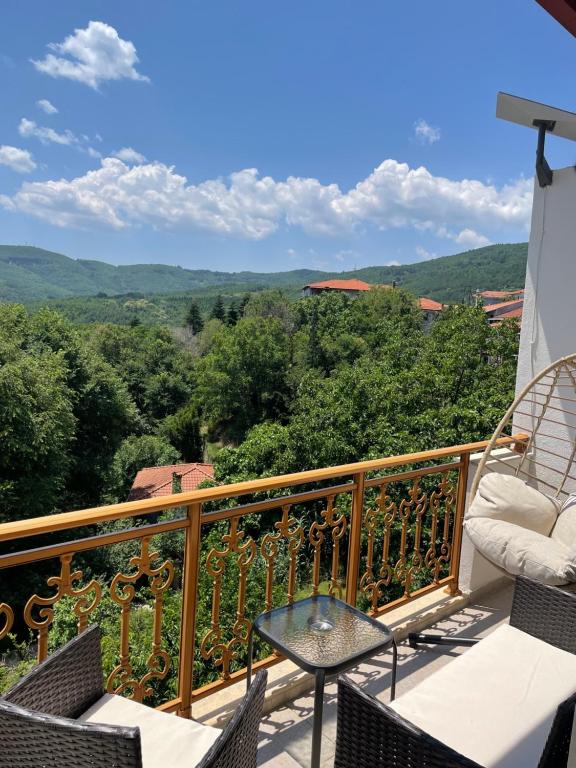 a balcony with chairs and a table and a view at Niki's Paradise View in Taxiarchis