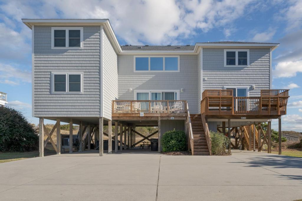 a large house with two decks on a beach at 4110 - Coop's Cottage in Duck