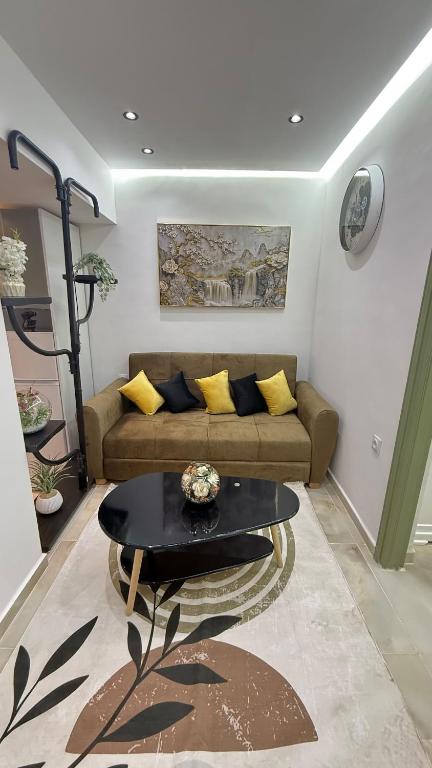a living room with a couch and a table at Olivia Loft in Birmandreis
