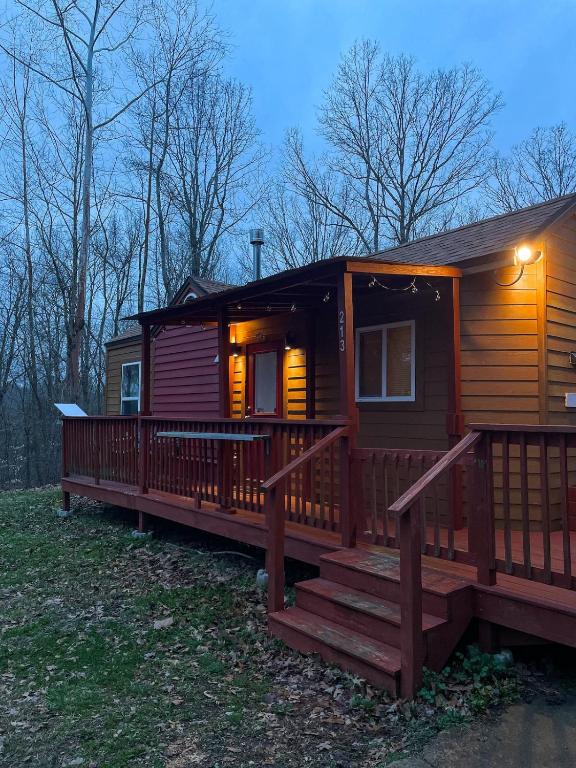a large wooden cabin with a large deck at The Self-Care Tiny Cabin in Parsons