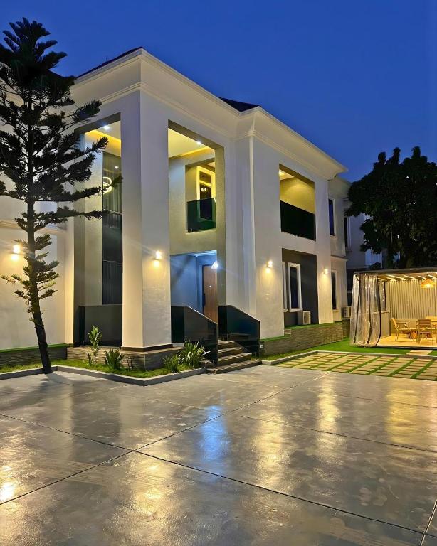 a large white house with a tree in front of it at The Mansion in Abuja