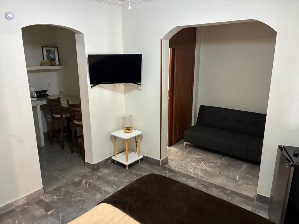 a living room with a couch and a tv at Depa 1 sf2 in Hermosillo