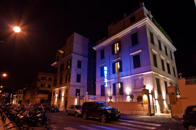 a building with a blue light on it at night at Hotel Center 1&2 in Rome