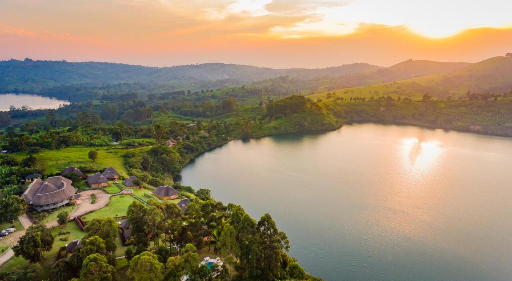 an aerial view of a lake at sunset at Crater Safari Lodge in Kibale Forest National Park