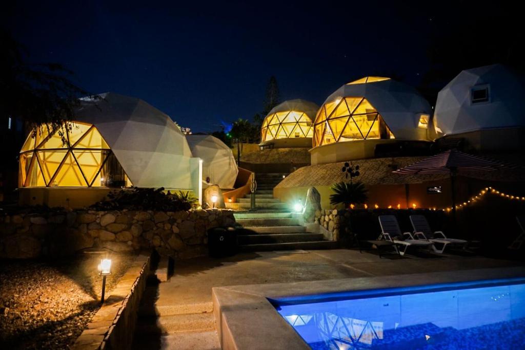 a house with a swimming pool at night at Los Domecitos - Geodesic Dome Retreat in Los Barriles