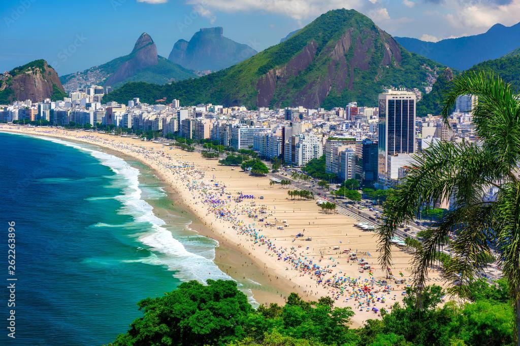 a beach with a crowd of people and buildings at Studio Copacabana Exclusivo, Na Rua Silva Castro, 4 min da Praia e Metrô, Ganhe 1 ESPUMANTE de boas vindas nas reservas acima de 3 dias, para brindar essa experiência icônica, com Ar e Wi-Fi in Rio de Janeiro