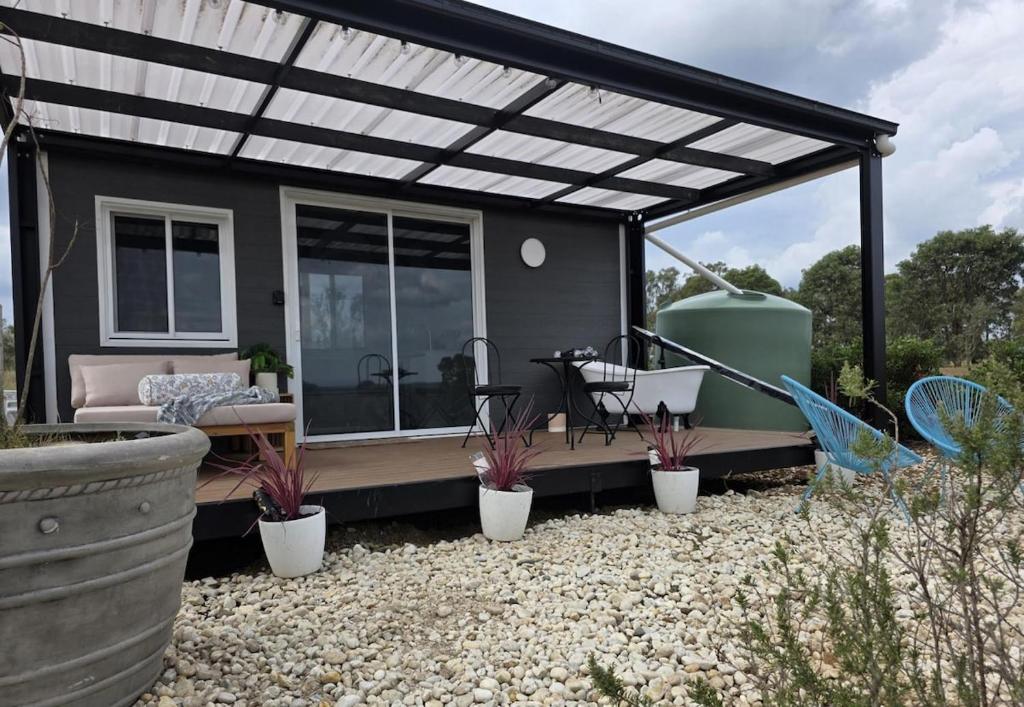 a house with a pergola and plants in a yard at Whispering Vines in Lovedale