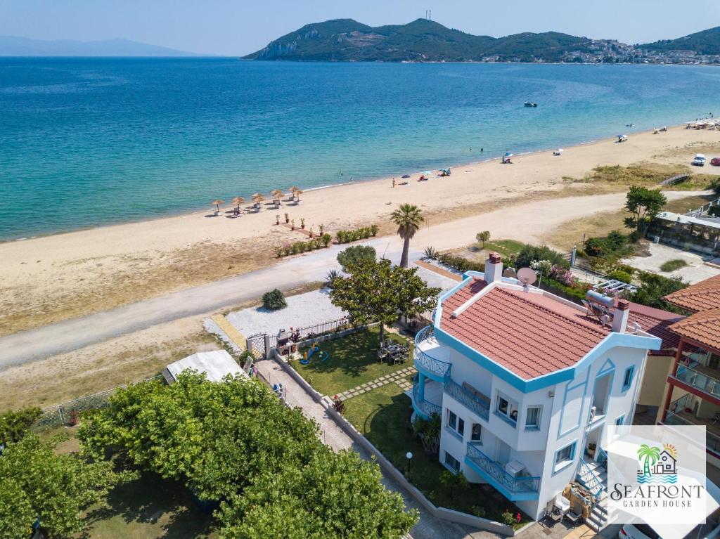 an aerial view of a beach with a blue house at SeafrontGardenHouse Villa in Iraklitsa