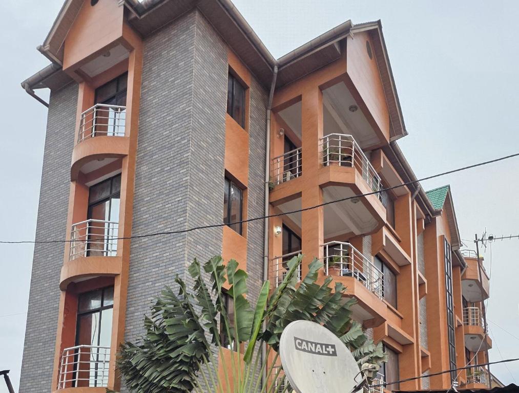 a building with balconies on the side of it at DAVAROXE Appartements Lingwala RTNC in Kinshasa