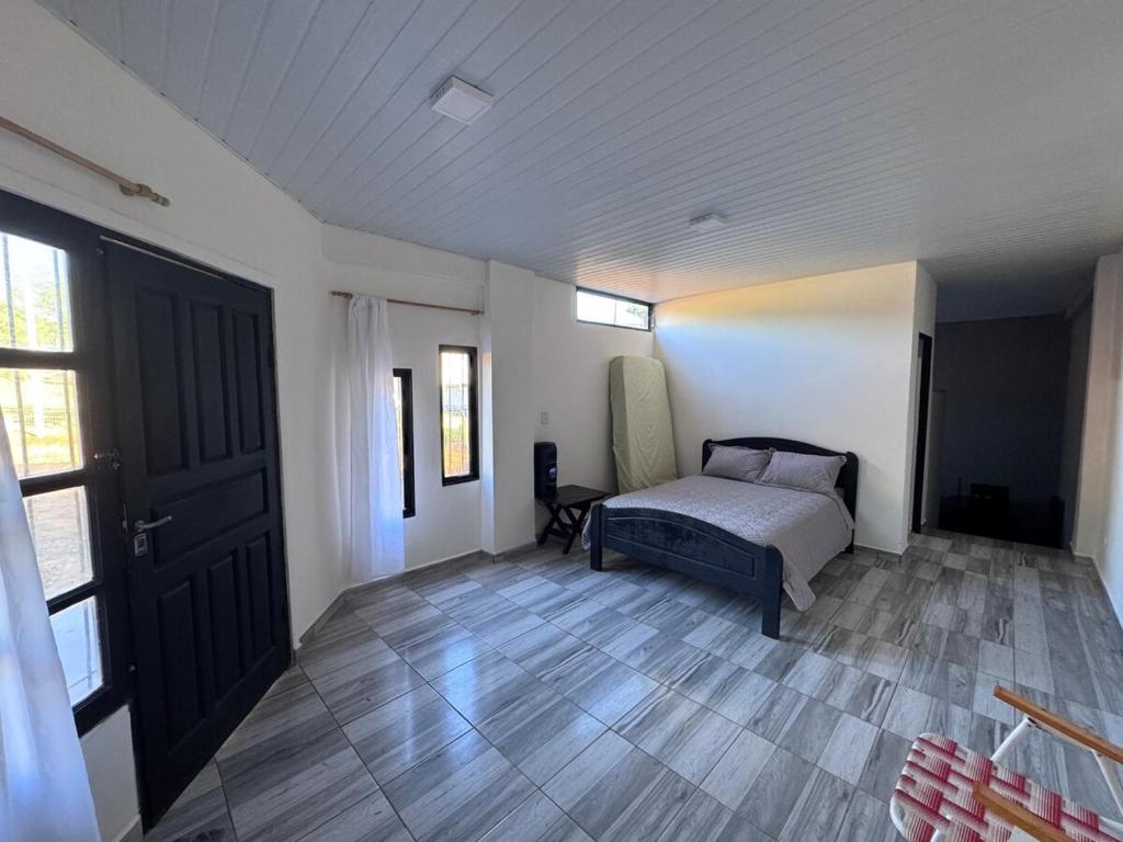 a bedroom with a bed and a wooden floor at Colar in Oberá
